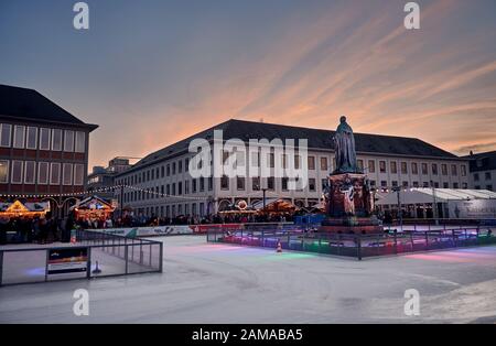 Karlsruhe, Baden-Württemberg/ Deutschland - 11. Januar 2020: Eiszeit-Schlittschuhbahn im Karlsruher Schlossgarten bei Sonnenuntergang beleuchtet Stockfoto