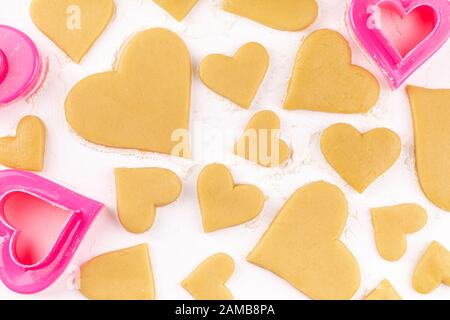Rohe Hausgemachte, Herzförmige Plätzchen mit Pink Cookie Cutter und Mehl Stockfoto