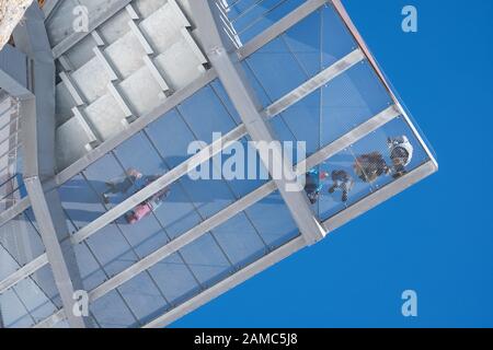 Menschen, die auf der Aussichtsplattform bei Birg in den Schweizer Alpen, fotografiert von unten. Unter der Stahlkonstruktion ist ein Höhenunterschied. Stockfoto