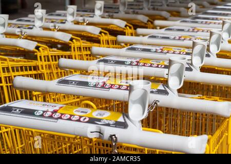 Reihen von gelben Einkaufswagen (Warenkarren) in einem Supermarkt in Frankreich. Stockfoto