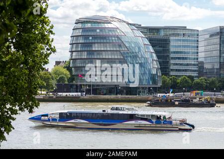 London, Großbritannien - 7. Juni 2017: Ein Vergnügungs-Kreuzfahrtschiff auf der Themse mit der London City Hall an der South Bank. In der City of London, England. Stockfoto