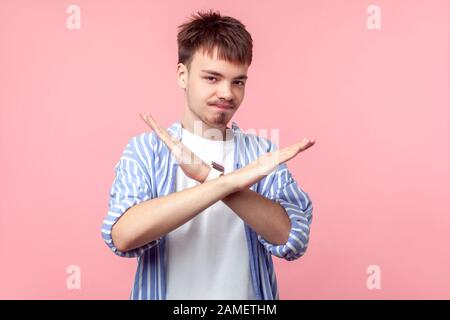 Es gibt keine Möglichkeit. Porträt des enttäuschten jungen braunhaarigen Mannes mit kleinem Bart und Schnurrbart in legeren Hemden, die die Hände kreuzen, Warnung mit Endgestur Stockfoto