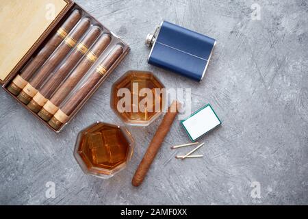 Karaffe von Whiskey oder Brandy, Brille und Schachtel finnest kubanischer Zigarren Stockfoto