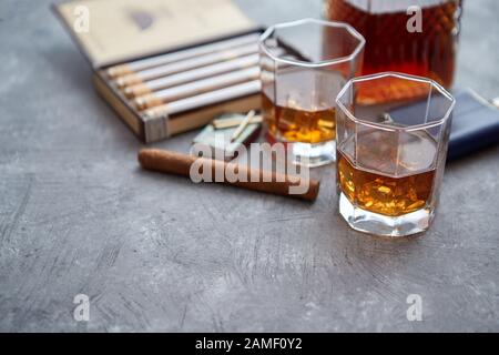 Karaffe von Whiskey oder Brandy, Brille und Schachtel finnest kubanischer Zigarren Stockfoto