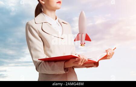 Frau, Rakete auf Buch öffnen Stockfoto