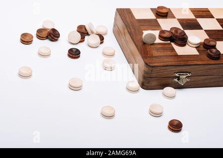 Holzkacheln und Schachbrett isoliert auf Weiß Stockfoto