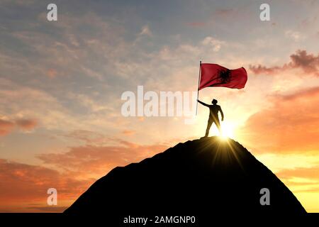 Albanische Flagge auf dem Gipfel eines Berggipfels winkt. 3D-Rendering Stockfoto