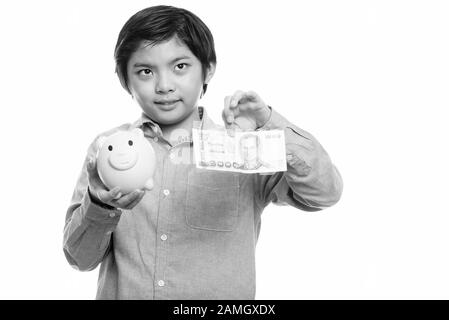 Nachdenklich Japanische junge Holding piggy Bank und 1000 Thai Baht Stockfoto