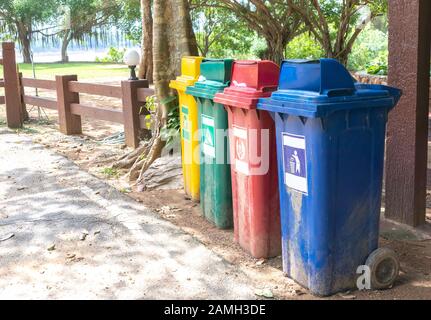 Papierkorb auf der Straßenseite gelb, grün, rot, blau. Stockfoto