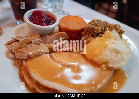 Nahaufnahme der Platte mit truthahn, Soße, Kartoffelpüree, Füllung, Yams und Preiselbeersauce, klassische Lebensmittel während einer traditionellen amerikanischen Erntedankmahlzeit, Danville, Kalifornien, 28. November 2019. () Stockfoto