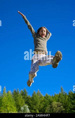 Kind voller Energie springt vor Freude Stockfoto