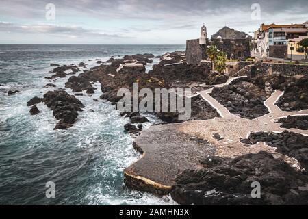 Die natürlichen Pools von El Caleton Garachico in einem Vulkanausbruch mit San Miguel Schloss im Hintergrund erstellt werden. Stockfoto