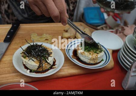 Frau, die Hausgemachte Agedashi Tofu mit Sojasoße kocht Stockfoto