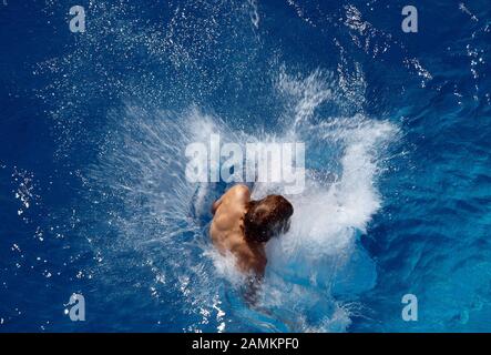 Junger Mann springt ins Freibad in Germering. [Automatisierte Übersetzung] Stockfoto