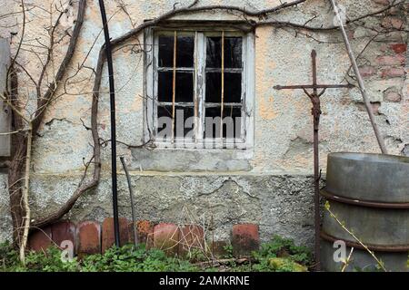 Altes Bauernhaus in der Badstraße 27 in Grafrath, vom Abriss bedroht. Das Bild zeigt eine Detailansicht mit einem alten schmiedeeisernen Grabkreuz. [Automatisierte Übersetzung] Stockfoto