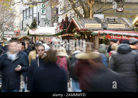 Weihnachtskäufer in der gut frequentierten Fußgängerzone in der Münchner Innenstadt. Im Hintergrund die Verkaufsstände des Christkindlmarktes. [Automatisierte Übersetzung] Stockfoto