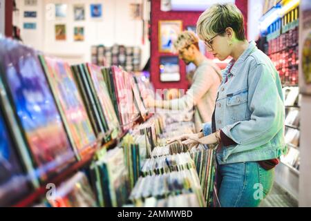 Junge Frau Wahl Vintage Vinyl LP In Records Shop Stockfoto