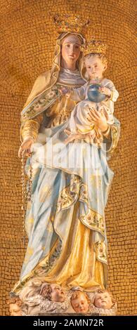 Menaggio, ITALIEN - 8. MAI 2015: Die geschnitzte polychrome Statue der Madonnenkirche Chiesa di Santo Stefano von Luigi Tagliaferri (1841-1927). Stockfoto