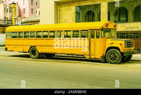 Vintage Schoolbus in Kuba - Havanna, alt und zur Mitzeit in einer staubigen Straße benutzt Stockfoto