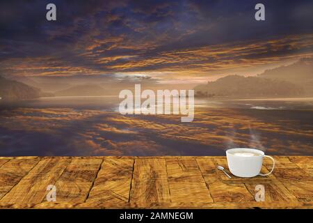 Die 3D-Wiedergabe von Holztisch an einem schönen Ort mit moderner Bürobecher mit heißem Kaffee im Hintergrund Stockfoto