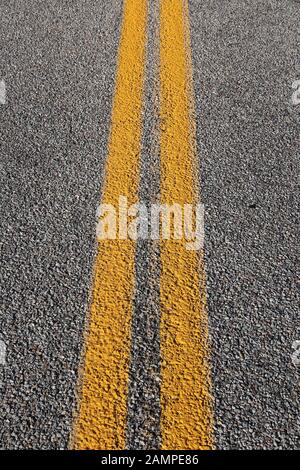 Asphalt Fahrbahn Fahrbahnoberflächen. Grauer Hintergrund mit der gelben Linie. Stockfoto