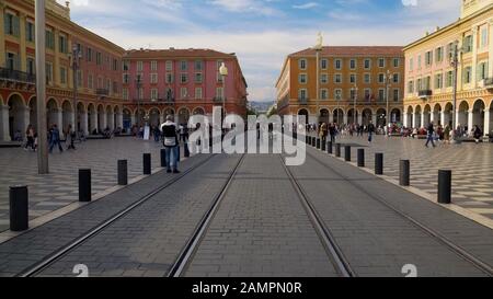 Trambahnen und bunte Architektur auf Dem Place Massena in Nizza, Frankreich Stockfoto