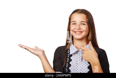 Überraschte Teenager-Mädchen, die ein Produkt zeigen. Schöne brünette Teenager-Mädchen mit langen Haaren, die auf die Seite zeigen. Ihr Produkt präsentieren. Isoliert auf weißem B. Stockfoto