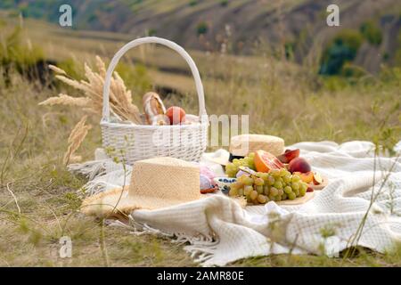 Stilvolle Sommer Picknick auf einer weißen Decke. In einem malerischen Ort der Natur der Hügel Stockfoto