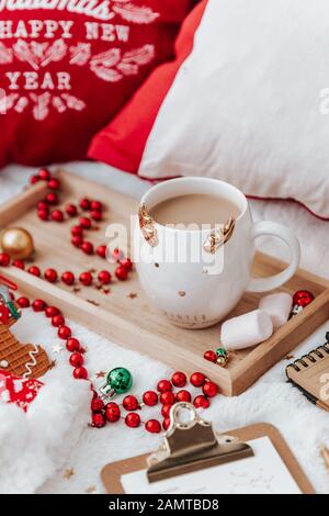 Lebkuchenplätzchen, Tee, Marshmallows und Weihnachtsdekorationen auf weißem Hintergrund Stockfoto