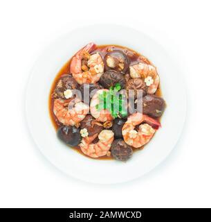 Gebratene Shitake-Pilze mit Garnelen in Oyster-Sauce asiatischer Küche chinesische Fusion Stil dekorieren Geschnitzten Knoblauch Draufsicht rühren Stockfoto