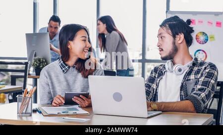 Zwei kreative Designer zwanglose Treffen mit Laptop im modernen Büro in Morgen am Schreibtisch. casual Arbeitsplatz Lebensstil. Stockfoto