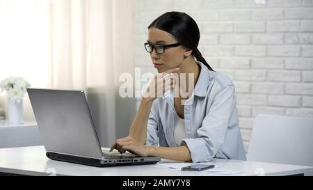 Asiatische Frau, die online professionelle Beratungen abgibt und über die Antwort nachdenkt Stockfoto