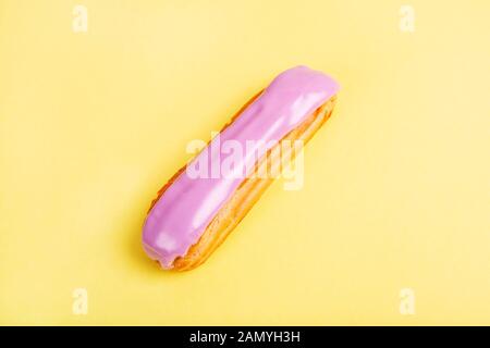 Eclairs aus Brombeeren und Blaubeeren auf gelbem Hintergrund. Overhead-Ansicht Stockfoto