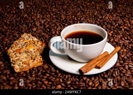 White Coffee Mug, Zimtstangen und Cookies auf die Kaffeebohnen background-image Stockfoto