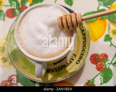 Tasse köstlichen Cappuccino im italienischen Stil mit Honigstreuer aus Holz Stockfoto