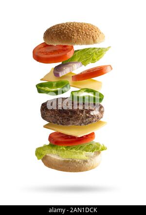 Hamburger sandwich Fliegen mit pflanzlichen Zutaten getrennt von den weißen Hintergrund, Salat, Zwiebeln, Tomaten, Käse, grüner Pfeffer Stockfoto