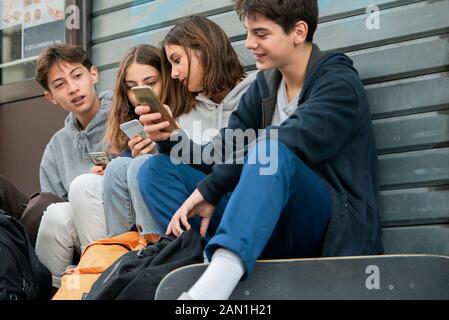 Freunde, die Ihr Smartphone im Freien verwenden Stockfoto