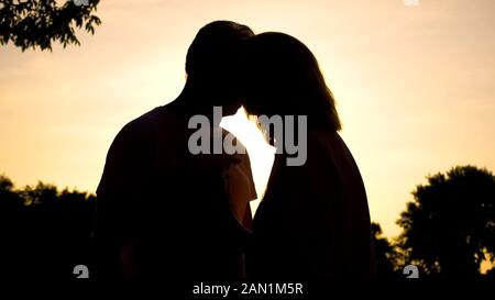 Ältere Paare küssen bei Sonnenuntergang, romantischen Moment, Liebe, Gefühl, Glück Stockfoto