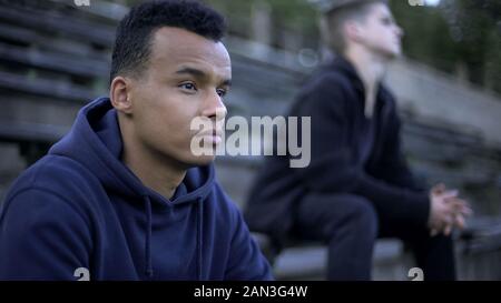 Verärgert Teenager sitzen auf Stadion Tribüne, Sport Spiel der Jugend team Stockfoto