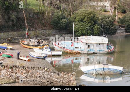 CONWY, Großbritannien - Februar 26., 2012. Ein älterer Mann repariert ein beiboot (kleines Boot) am Ufer in Conwy, Wales Stockfoto