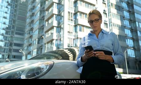 Businesslady Lesen von E-Mails auf dem Smartphone, Prüfungsschema, geschäftigen Lebensstil Stockfoto