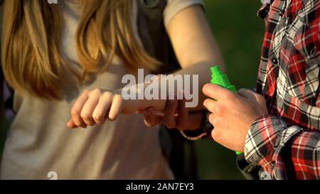 Mann Anwendung kühlen Creme auf ladys Arm nach Mücken beißen, Insektenschutz Stockfoto