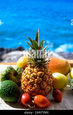 Tropische Früchte Sammlung, Custard Apple oder Grün reif cherymoia, Maracuja, Ananas, Mango, tamarillo, Avocado exotische Früchte auf blaues Meer hinterg Stockfoto