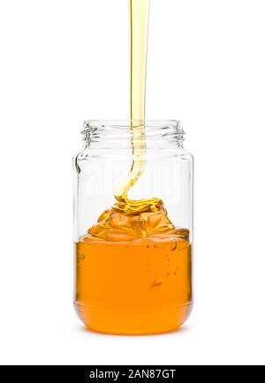 Honig verschütten in Glas, auf weißem Hintergrund Stockfoto