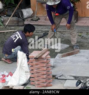 Bangkok, Thailand - 25. Dezember 2019: Baustelle Männer installieren neues Straßenbelag. Stockfoto