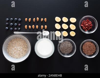 Ansicht von oben knolling Schuss gesundes Frühstück mit Haferflocken, Samen, Beeren und Früchte, gesundes Essen flach Konzept Stockfoto