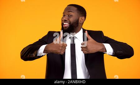 Happy afro-amerikanischen Geschäftsmann Herstellung doppelter Daumen-nach-oben-Geste, Empfehlung Stockfoto