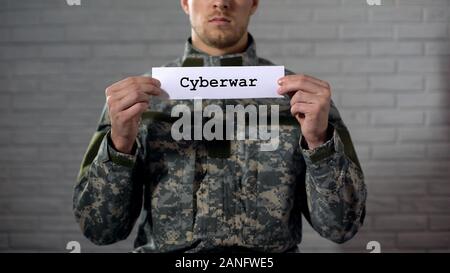 Cyberwar Wort auf Zeichen in den Händen der männlichen Soldaten geschrieben, Informationssicherheit Stockfoto