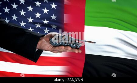 Offizielle hand Spielzeug Tank gegen USA und VAE Fahnen, militärischen Konflikt Stockfoto