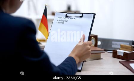 Botschaft zur Genehmigung der Mitarbeiter Visa Application, deutsche Fahne auf dem Tisch, Berechtigung Stockfoto